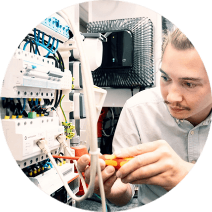 An engineer wiring test hardware in the EnQS lab